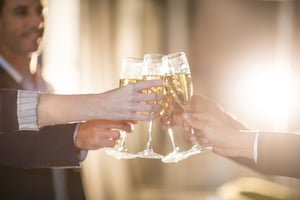 Close-up of group of businesspeople toasting glasses of champagne in the office